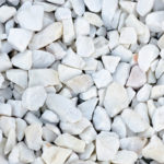 Small stones of white color with gray-blue tint. Close up texture.